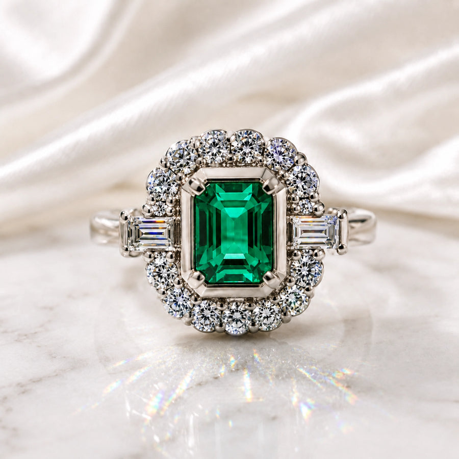 Emerald halo ring on satin showing a refreshed jewellery remodelling direction