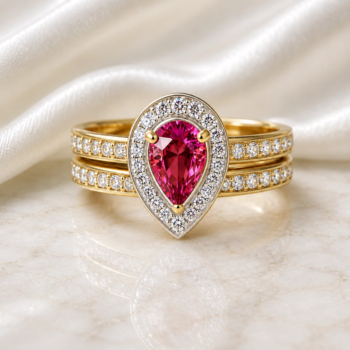Pink sapphire pear-cut halo bridal ring set in yellow gold