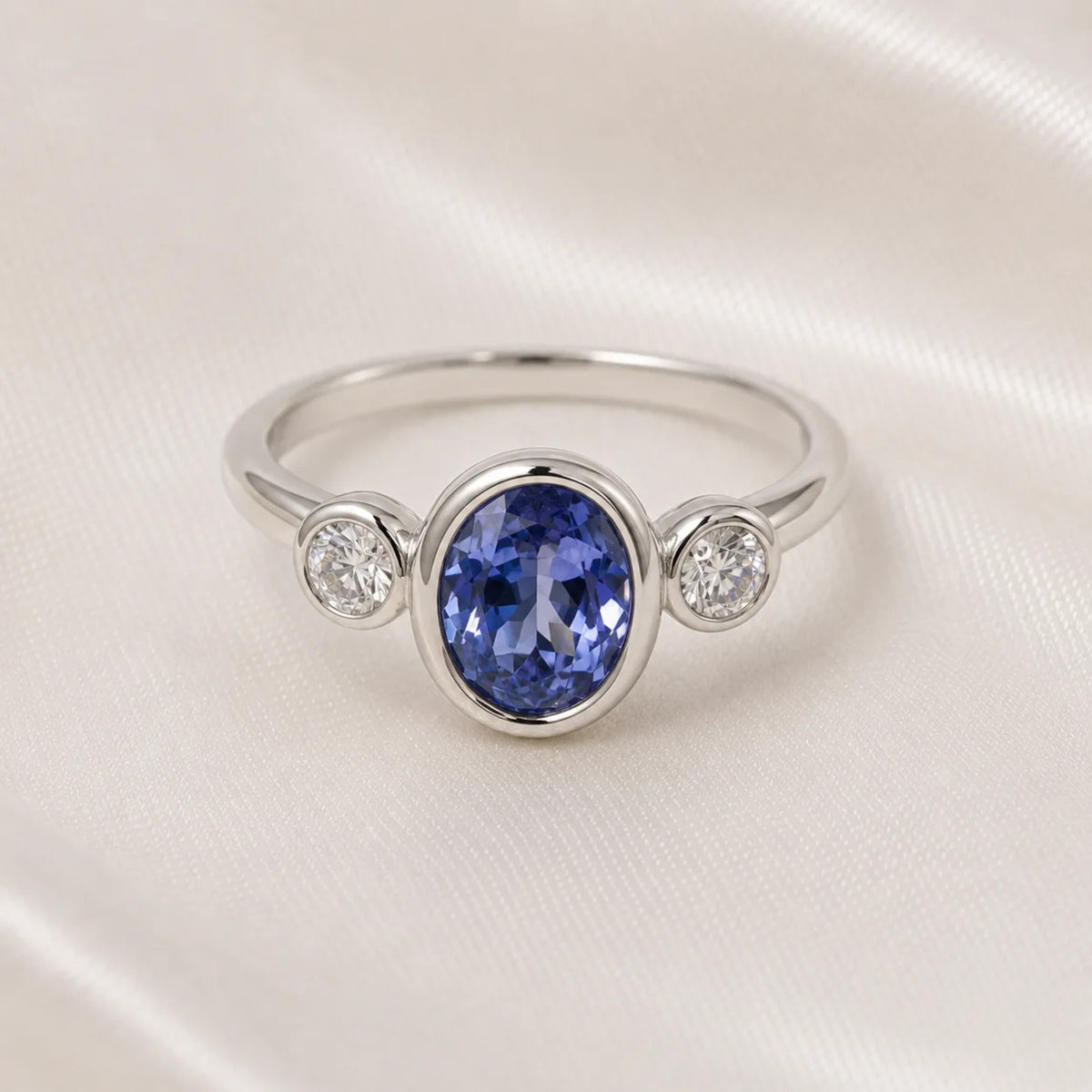 Tanzanite and diamond three-stone ring in white gold